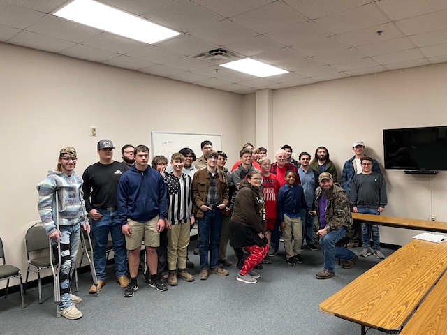 Current and former Troop 8 members stand around Mr. Joe for one last group photo.